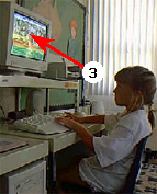 child seated at computer station with arrow 3 pointint at computer monitor that is too high