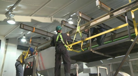 Screen shot of video with a man using fall arrest equipment
